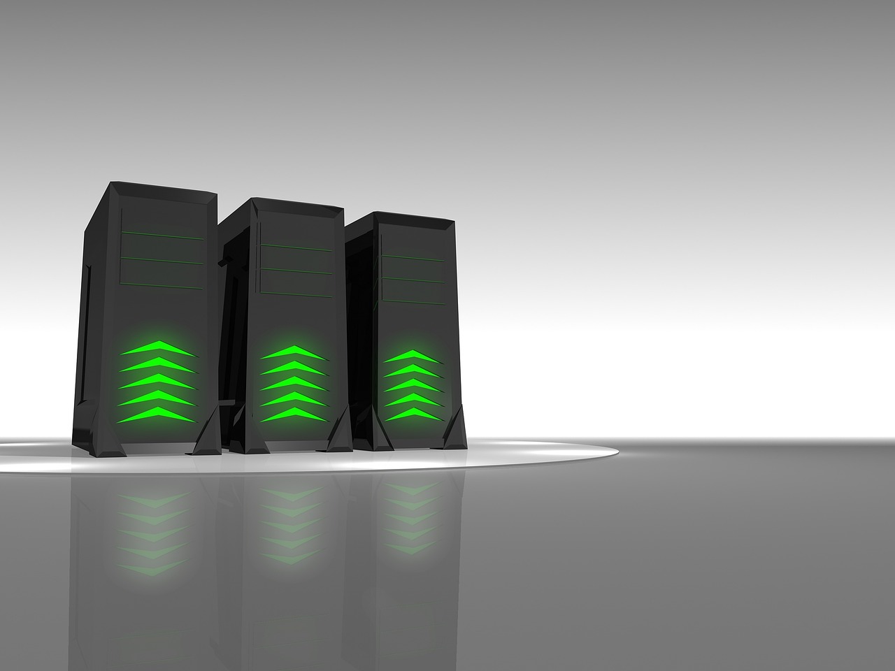 Three black server towers with glowing green indicators on a reflective surface