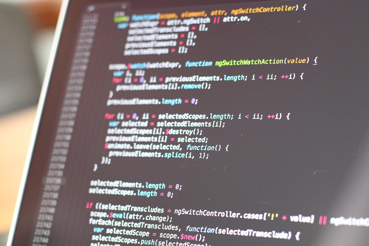 JavaScript framework source code with scope and controller functions, shown on a screen.