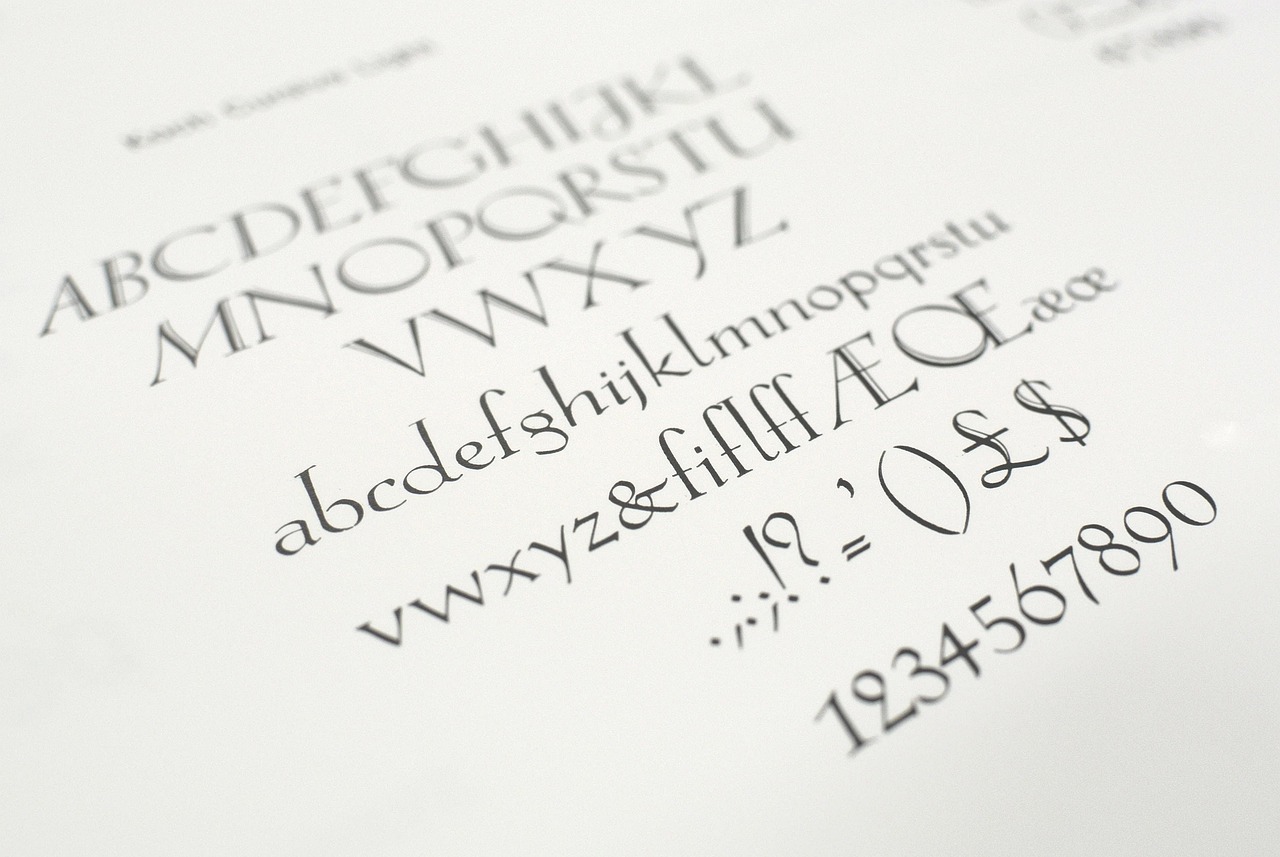 A printed type specimen sheet showing an alphabet in uppercase and lowercase with ligatures and numerals