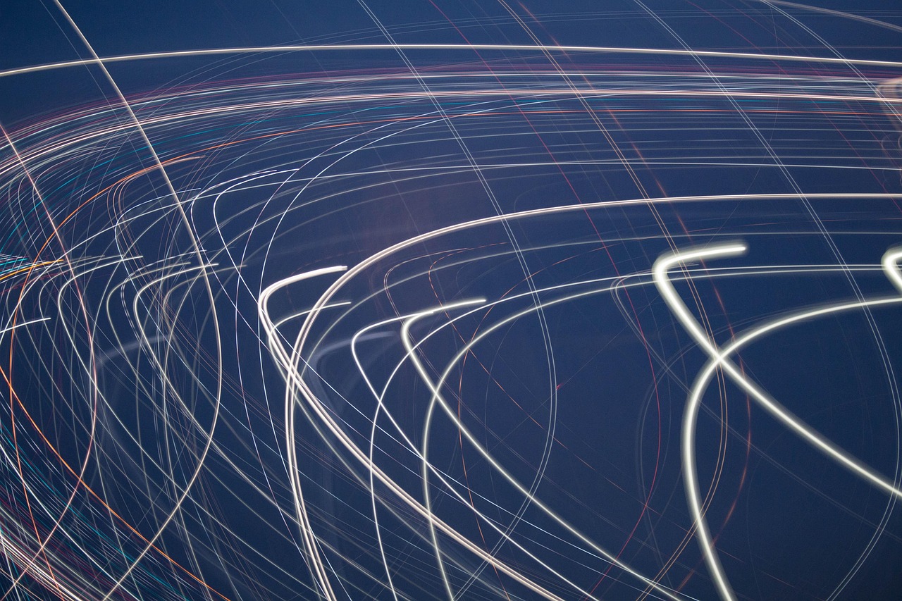 Abstract glowing light trails suggesting speed and motion